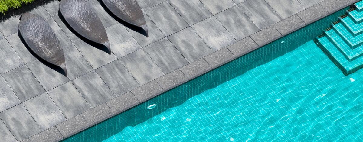 Pool with patio using Nueva XL Slab and Oasis Bullnose Coping products from Brampton Brick