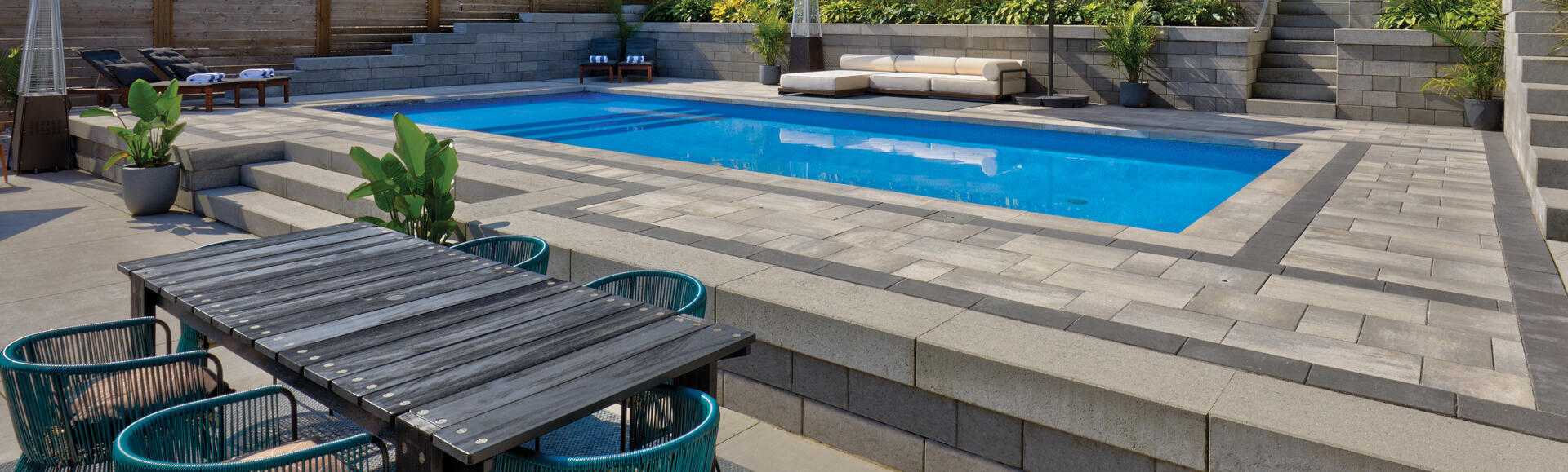 Patio with pool using Nueva Slab and Proterra Wall products from Oaks